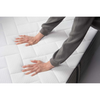 Person testet die Festigkeit der Bico Basics 4 Matratze 90x200 cm mit beiden Händen