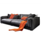 Candy Megasofa King Size Anthrazit mit orangefarbenen Kissen und Decke – grosses Ledersofa für maximalen Komfort