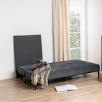 Actona Perugia Bettsofa in Dunkelgrau, ausgeklappt als Schlafsofa mit Überwurf und aufgeschlagenem Buch