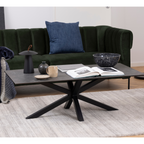 Actona Heaven Salontisch in Betonoptik mit schwarzem Sterngestell vor dunkelgrünem Samtsofa