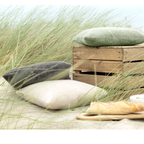 Magma Kissen Bamboo 50x50cm in Sand, Grau und Grün auf Stranddünen mit Holzkiste – Outdoor-Dekokissen