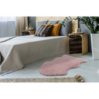 Lalee Kunstfell Cosy in Rosa vor modernem Bett mit Naturholz-Nachttischen und Dekokissen im Schlafzimmer