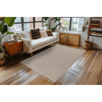 Lalee Tunis Teppich in Beige mit Fransen im modernen Wohnzimmer mit weissem Sofa und Holzboden