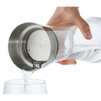 Cilio Vetro Wasserkaraffe aus Glas mit Edelstahldeckel beim Einschenken von Wasser in ein Glas