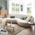 Gutmann Megasofa New Spirit in Weiss mit Bouclé-Bezug im modernen Wohnzimmer mit Holzboden und grüner Wand