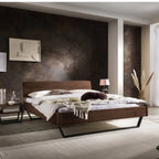 Modernes Schlafzimmer mit Holzbett, dunkler Akzentwand und eleganter Einrichtung - Schweizer Design.